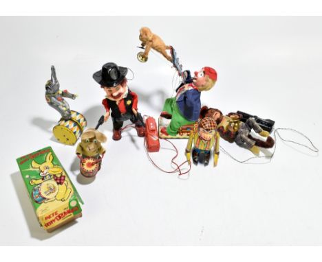 A group of assorted battery operated and clockwork tin plate and plush toys, including Pete the PP Drummer, a model of a clow