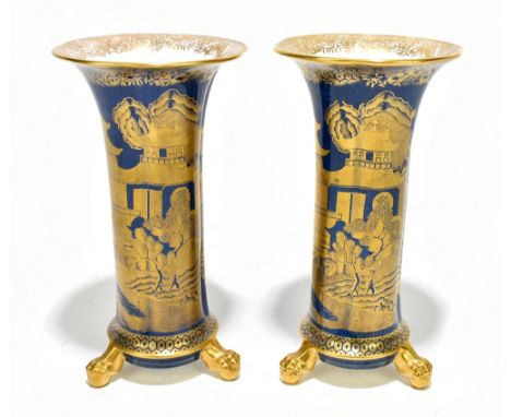 SPODE; a pair of Copelands china Chinoiserie decorated gilt heightened blue ground vases of trumpet form raised on three ball