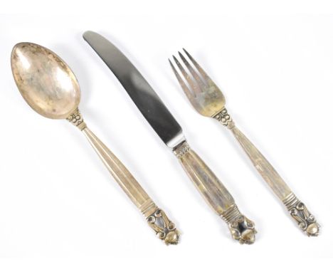 GEORG JENSEN; a three piece sterling silver christening set comprising spoon, fork and silver handled knife with stainless st