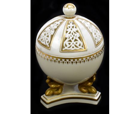 An unmarked Royal Worcester potpourri gilt heightened cream ground bowl and cover raised on three stylised serpent supports t