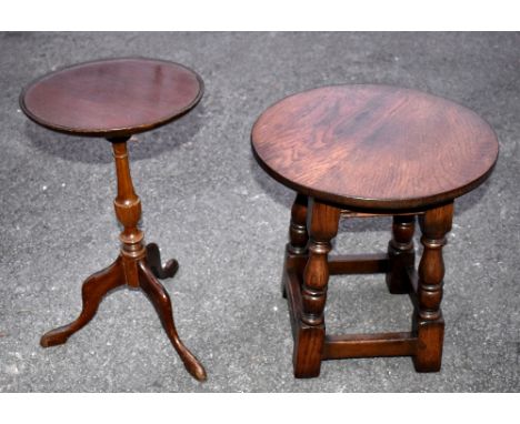 A reproduction oak circular top coffee table raised on block feet, height 43cm, depth 41cm, with a reproduction mahogany trip