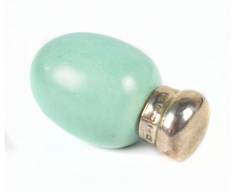 ATTRIBUTED TO MACINTYRE; a pale blue egg shaped scent bottle with silver cap hallmarked Birmingham 1911, length 3.7cm.Additio
