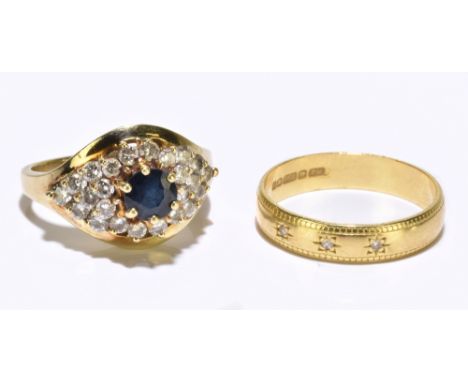 A 14ct yellow gold dress ring set with a central blue stone and a melee of diamonds, approx. size I, with an 18ct yellow gold