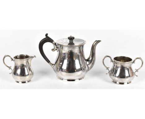 JOHN ROUND; a George V silver three piece silver tea service comprising teapot, milk jug and twin handled sugar bowl, the tea