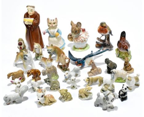 A group of ceramic figures including a Royal Worcester candle snuffer in the form a monk, a Beswick wall mounted swallow, a B