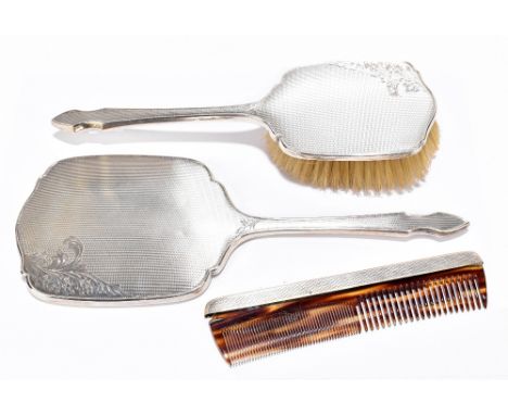 A matched three piece hallmarked silver back dressing table set, the mirror and hand brush Birmingham 1954 and 1955, the comb