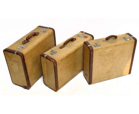 Three vintage leather bound suitcases, two with silvered initials EED, width of largest 66cm, one with the remains of a New H