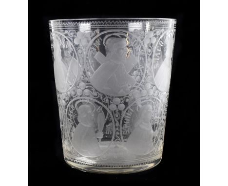 An unusual large glass beaker engraved with twelve roundels, each depicting one of the twelve apostles and inscribed with the