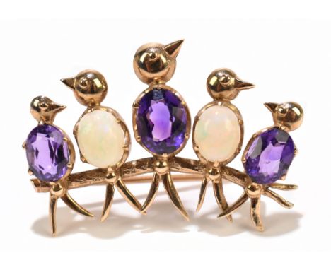 A novelty yellow metal amethyst and opal brooch modelled as four birds seated upon a branch, unmarked, width 38mm approx 6g.A