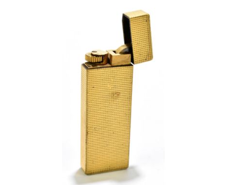 CARTIER; a gold plated cigarette lighter with engine turned detailing, height 7cm.Additional InformationA patina of age wear,
