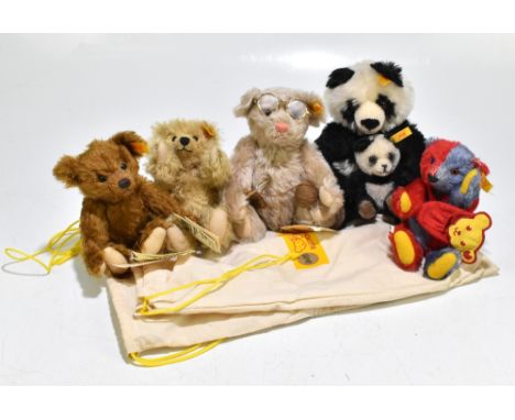 STEIFF; four small size teddy bears and a Steiff panda bear, three with original Steiff bags (5).