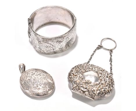 A Victorian white metal locket, with engraved detailing, with an Edwardian hallmarked silver purse and a silver bangle, gross