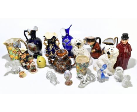 A collection of decorative ewers, animal models and character jugs to include a pair of Staffordshire chimney dogs, a Goebel 