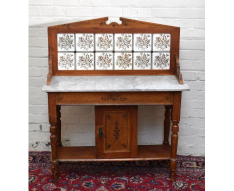 A Victorian painted pine marble topped wash stand with tile back and single panelled cupboard door, width 107cm, depth 46cm, 