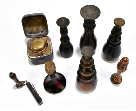A group of wooden seals including a lignum vitae example, a gilt metal example also a travelling inkwell (8).Additional Infor