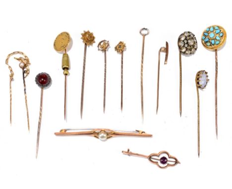 A group of predominately yellow metal stick pins, one set with turquoise, one set with a coin, one set with seed cultured pea