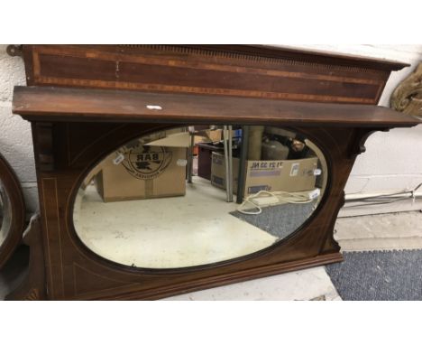 An Edwardian Sheraton Revival mahogany overmantel mirror, with central bevel edged oval plate, surmounted by a plain shelf, 1