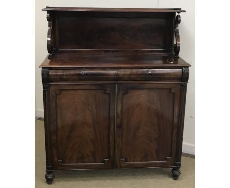 A 19th Century mahogany chiffonier, the shelved back on brass rail and S scroll supports over two cushion drawers and two fig