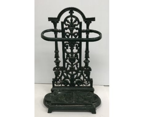 A Victorian style green enamelled stick stand and contents of various walking sticks, umbrella and shooting stick