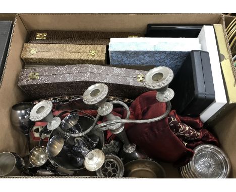 A box of assorted plated wares to include a three light candelabra, various glass and plated coasters, assorted cutlery sets,