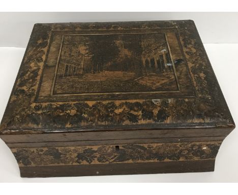 A 19th Century Tunbridge ware rectanagular hinged lidded box with waisted sides, the top set with architectural scene with tr