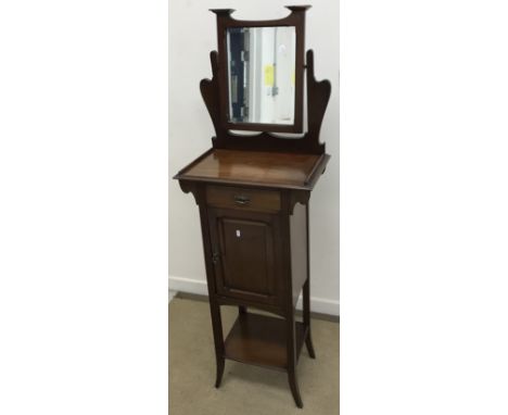 A circa 1900 mahogany wash or shaving stand of slim proportions, the adjustable mirror over  a single drawer and cupboard doo
