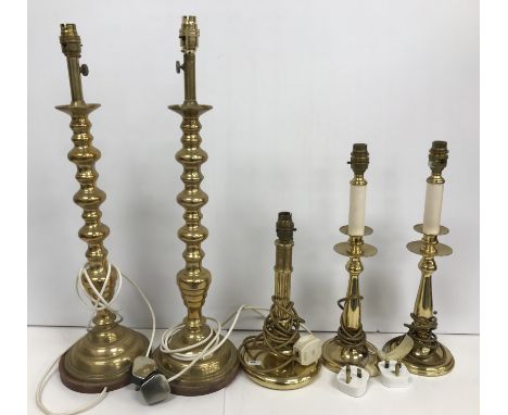 A pair of Victorian style brass bobbin table lamps of candlestick form, 63 cm high including bayonet fixing, another smaller 