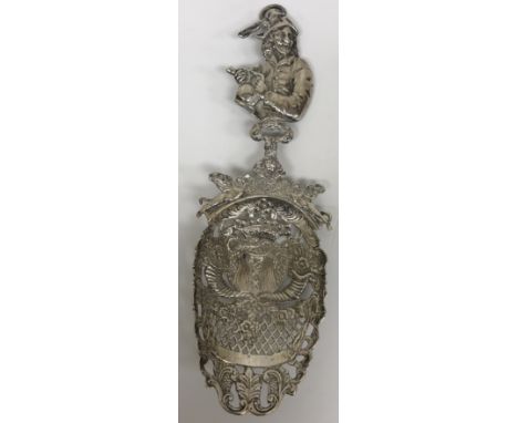 A 19th Century German silver pierced and engraved spoon / sifter, the figural handle depicting a toper with jug of ale and cl
