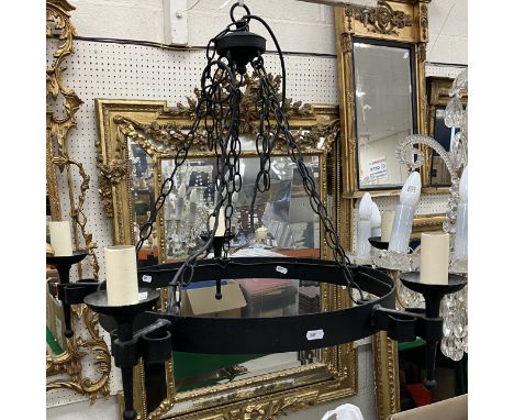 A modern black painted wrought iron ceiling light of circular form set with five candle type lights approx. 72 cm wide 