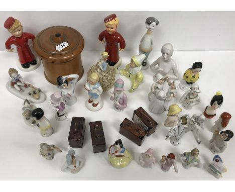 A collection of pin cushion dolls, various other Continental porcelain figurines to include Goebel "Bellboy" figures and a bo