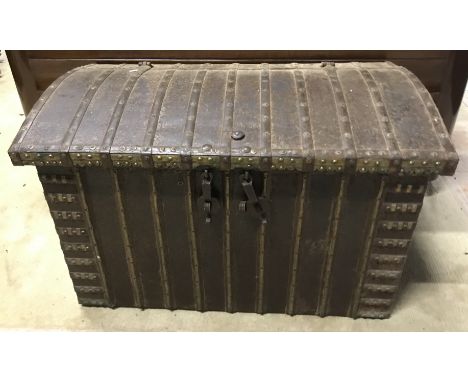 An Indian studded iron bound dome top dowry trunk with two hasp and staple locks and heavy iron carrying handles, 96 cm wide 