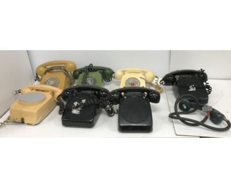 A box of seven vintage mid 20th Century telephones, including three black, one green, one cream/white, one mustard yellow and