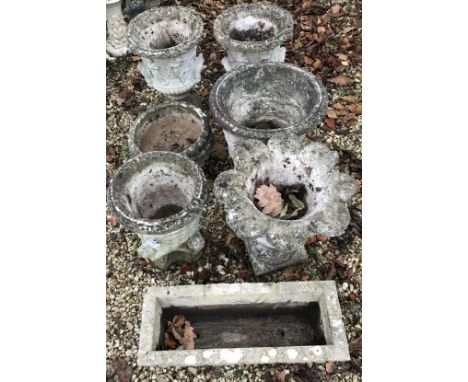 A collection of composite stone garden pots to include a pair with Classical figural decoration and a trough (7)