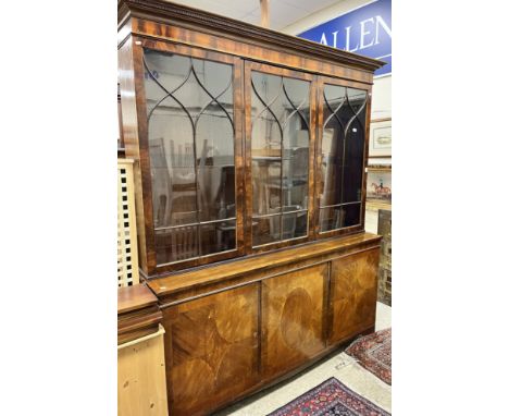 A modern reproduction mahogany bookcase cabinet in the George III taste, the top with moulded cornice over three glazed cabin