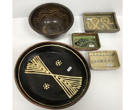 A collection of Winchcombe pottery including an oval slip ware dish, 32 cm long x 28.5 cm wide x 5.5 cm high, three small rec