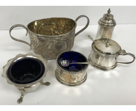 A Victorian silver and embossed oval sugar basin with gilt-washed interior and two fluted loop handles (by William Charles Fo