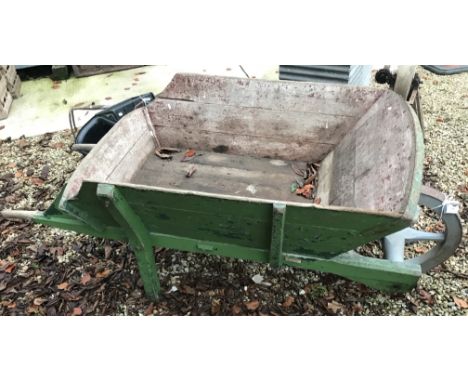 A vintage over-sized wooden wheelbarrow, 205 cm long x 103 cm wide x 86 cm high
