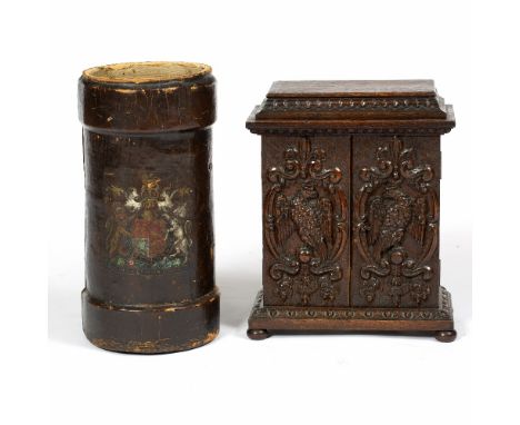 A CONTINENTAL OAK SMALL CUPBOARD, the doors carved in relief with eagles and scrolling foliage, on bun feet, 32.5cm wide; and