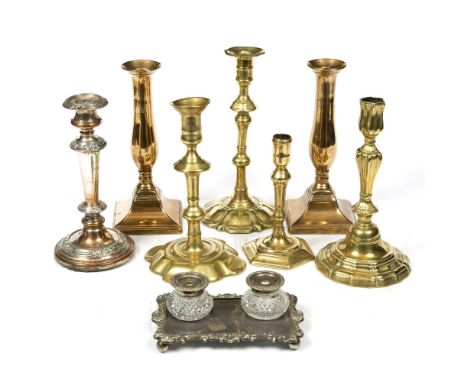 AN 18TH CENTURY BRASS CANDLESTICK, with knopped stem and shaped circular base, 22.5cm high; two further similar candlesticks;