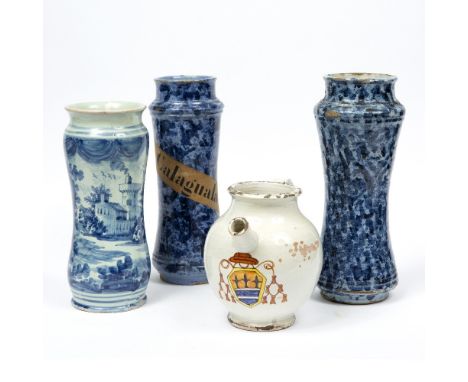TWO SIMILAR ITALIAN MAJOLICA ALBARELLI, with sponged blue decoration, one with printed paper label for R Calaguara, 30cm high