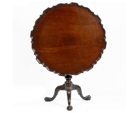 A GEORGE III MAHOGANY PIECRUST SUPPER TABLE, the shaped top on a bird cage support with fluted central column and carved trip