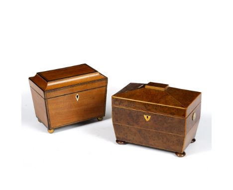 AN EARLY 19TH CENTURY BURR WALNUT AND BOX STRUNG TEA CADDY, of sarcophagus form, fitted with two lidded compartments, on bun 