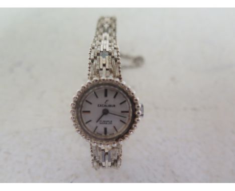 A ladies silver cased cocktail watch white enamel dial with baton markers by Excalibur on a silver strap marked .925