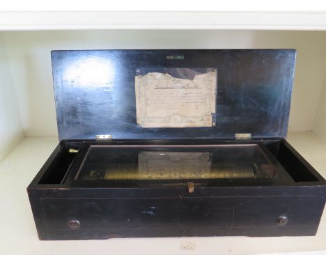 A Victorian cylinder music box with floral inlaid decoration to lid - 58cm x 23cm x 15cm high - various parts of comb missing