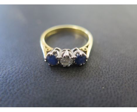 An 18ct gold sapphire and diamond three stone - Diamond approx 0.20ct - Ring size R - Weight approx. 4.5grams 