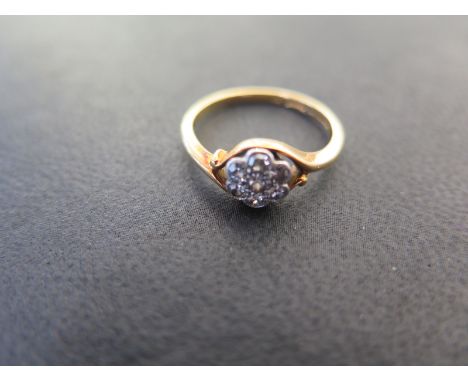 An 18ct gold cluster ring size K - approx weight 1.2 grams - diamonds bright, some usage wear