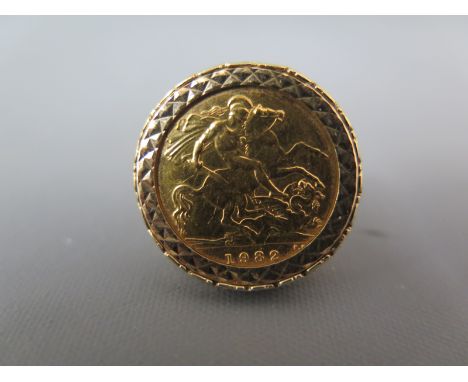 A 9ct gold ring with a half Sovereign to shoulder - ring size J - Sovereign 1982 - some light scratching to Sovereign approx 