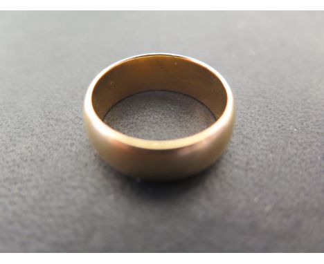 An 18ct gold band ring - size Q - Weight approx. 10gms 
Condition report: Some usage marks