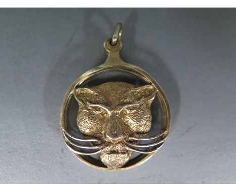 A silver gilt hallmarked hinged magnifying glass with large cat head motif to one part, glass to other, hallmarked for London