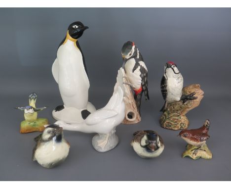 A collection of eight ceramic birds: Beswick 2420 Lesser Spotted Woodpecker, Beswick 993 Small Wren, Goebels CV87 Greater Spo